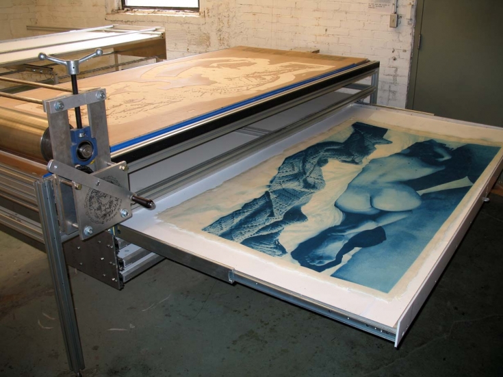 Sara woodcuts in press take-up drawer -- 14 of 17 blocks have been printed